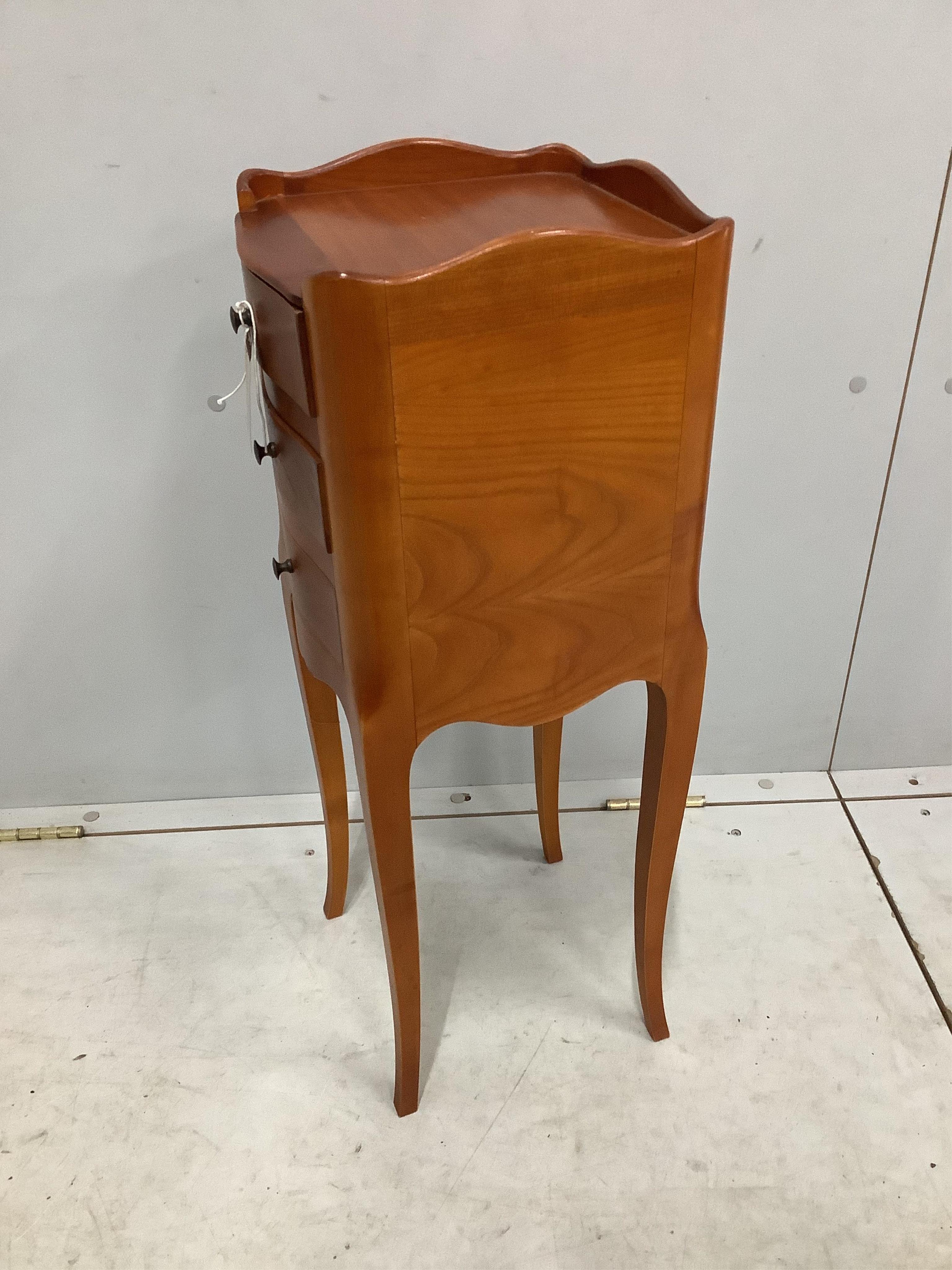 A pair of French cherry three drawer bedside chests, width 24cm, depth 26cm, height 70cm. Condition - fair to good